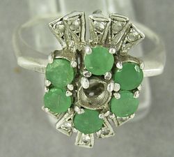 Silver ring missing an emerald