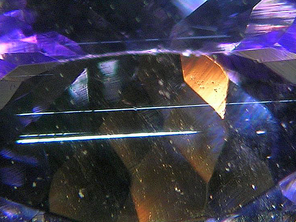 Tanzanite detail, just part of a cut stone, showing growth tubes